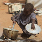 Child cooking in a refugee camp, Kenya
